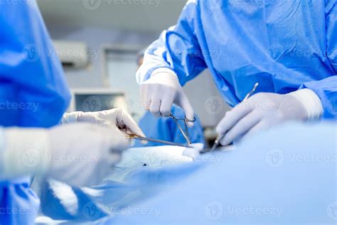 Team Of Professional Doctors Performing Operation In Surgery Room