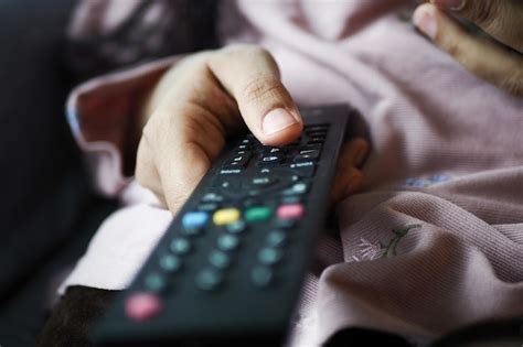 Premium Photo Close Up Of Women Hand Holding Tv Remote