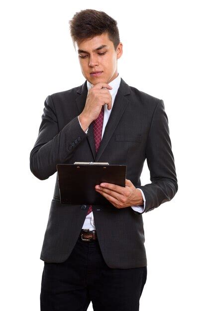 Premium Photo Young Handsome Businessman Reading On Clipboard While