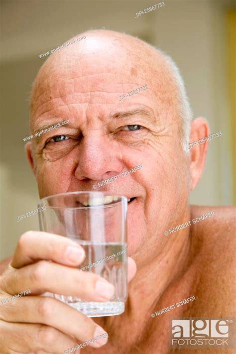 Portrait Of Man Drinking Glass Of Water Stock Photo Picture And