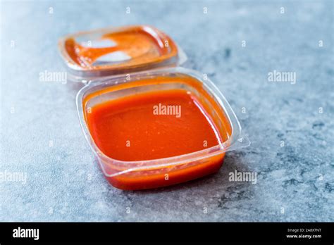 Hot Spicy Red Sriracha Sauce In Plastic Box Package Or Container For Fast Food Ready To Eat