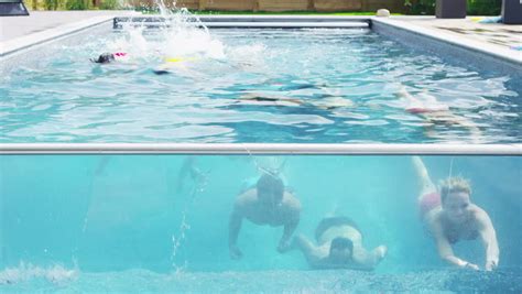 Athletic Group Of Attractive Young Friends Swim Underwater In Swimming