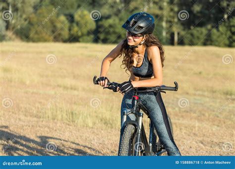 Girl On A Mountain Bike On Offroad Beautiful Portrait Of A Cyclist At