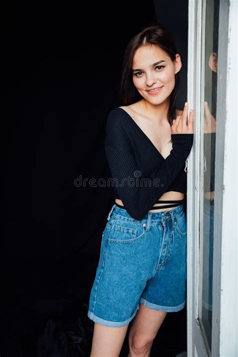 Brunette Woman And Standing At The Door From The Room Stock Image