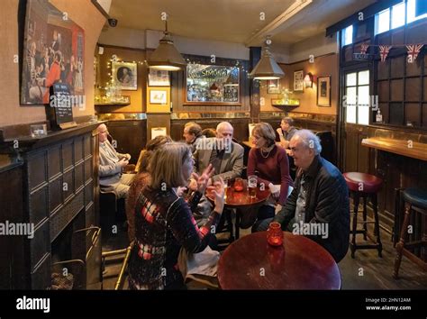 UK Pub interior; People drinking inside The Lamb & Flag pub, a ... 