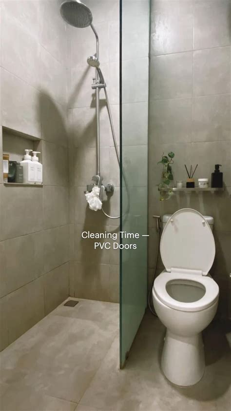 A White Toilet Sitting In A Bathroom Next To A Shower