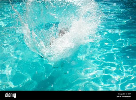 View of big splash in swimming pool Stock Photo - Alamy