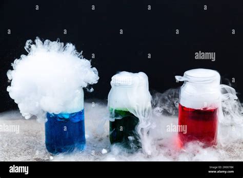 Fun Science Experiment With Dry Ice And Coloured Water And Detergent On Black Backdrop Stock