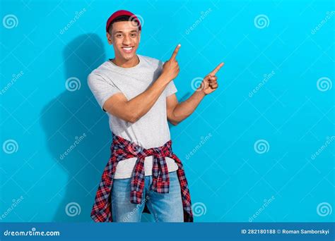 Photo Of Positive Sweet Guy Dressed Grey T Shirt Pointing Two Fingers Empty Space Isolated Blue