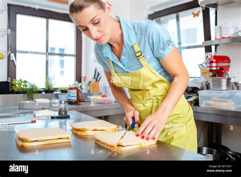 Close Up Of A Female Chef Cutting Sandwich Stock Photo Alamy