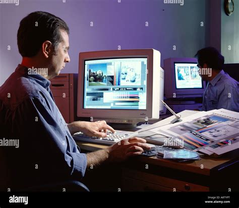 Man in design office sitting at desk using computer design system Stock Photo - Alamy