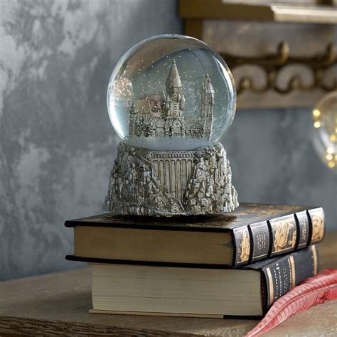 A Snow Globe Sitting On Top Of Two Books