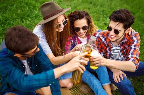 Premium Photo | Bottles of beer Group of friends enjoying partypeople ...