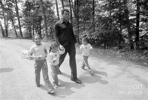 Muhammad Ali Walking With Twin Daughters by Bettmann