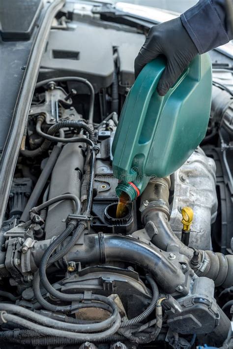 Mechanic Pouring Oil To Car Engine Auto Motor Service Stock Photo