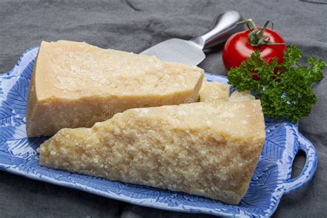 Italian Original Aged Parmesan Cheese in Two Pieces Served on Blue Plate Close Up Stock Image ...