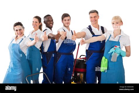 Portrait Of Smiling Janitors Gesturing Thumbs Up On White Background