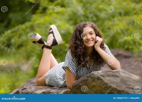 Teenage Girl High School Senior Brunette Smiing on Rocks Stock Image ...