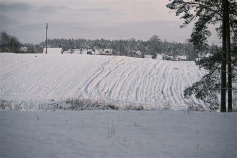 Premium Photo Snowcovered Farm Field In Winter