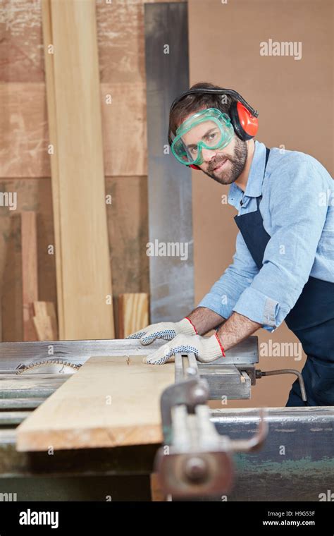 Carpenter Cutting Wood Using Protection Stock Photo Alamy