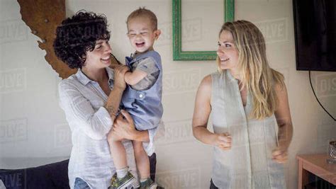 Caucasian Lesbian Mothers And Baby Son In Living Room Royalty Free Stock Photo Dissolve