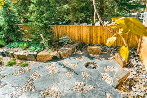 Rundle Stone and River Rock Patio with Fire Pit & Stone Seating - Rustic - Patio - Calgary - by ...