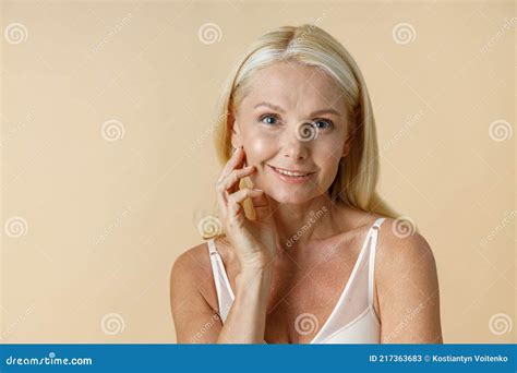 Portrait Of Pretty Mature Woman With Blonde Hair In White Underwear