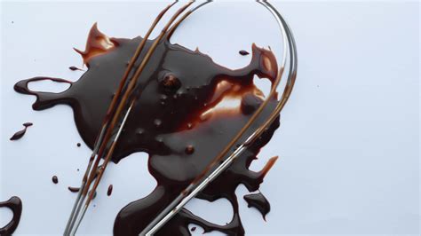 Whisk in chocolate sauce on white surface 13826606 Stock Video at Vecteezy