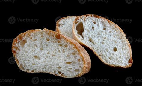 Ciabatta A Loaf Of Bread Cut In Half Isolated On A Black Background