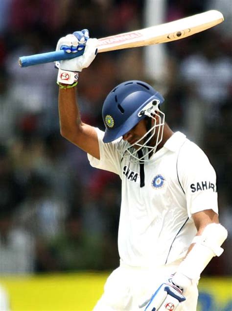 Rahul Dravid raises his bat on completing his half-century ...