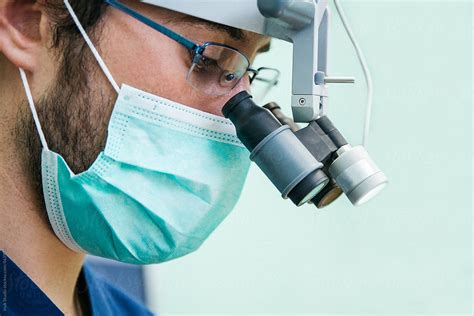 «Portrait Of A Dentist With A Surgeon Mask And Microscope Glasses ...