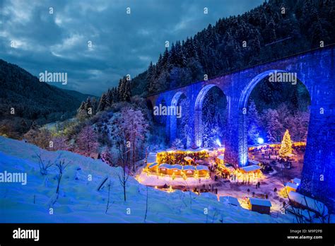 Snowy Christmas Market Under A Railway Viaduct Illuminated