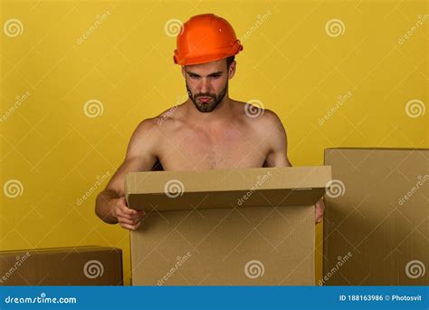 Sexuality And Building Concept Naked Builder Opening Box Stock Photo