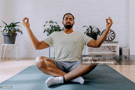 young black man  yoga  home   living room high res stock