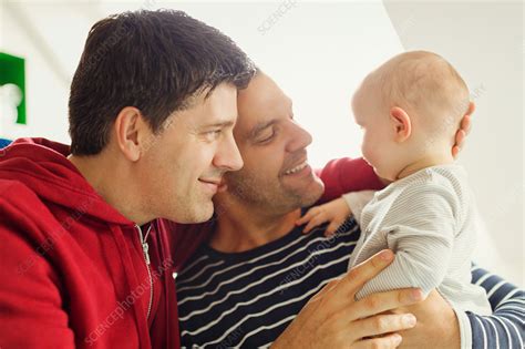 Affectionate Male Gay Parents Cuddling Baby Son Stock Image F Science Photo Library