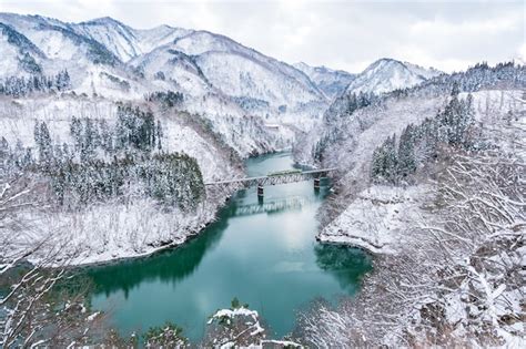 Premium Photo | Beautiful landscape of tadami line train across tadami ...