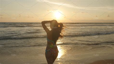 Attractive Sexy Girl With Long Hair Posing On The Ocean Shore At