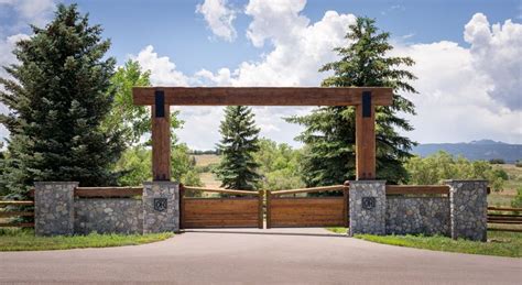 a gated entrance to a wooded area with trees