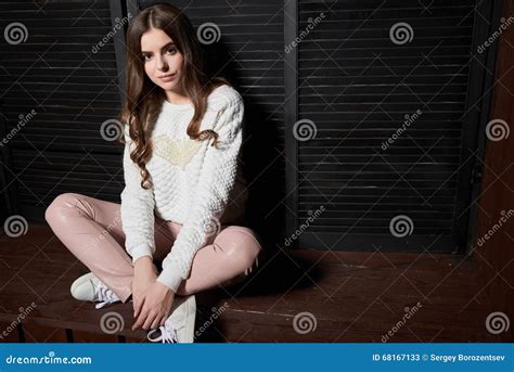 Portrait Of Beautiful Woman In Pink Pants And White Sweater Stock Image