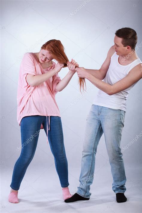 Young boy pulling girl's hair — Stock Photo © photographee.eu #47945053