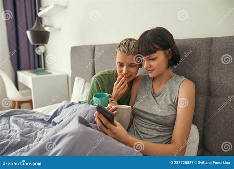 Young Lesbians Watching On Smartphone On Bed Stock Image Image Of