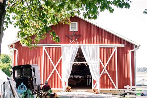 A Red Barn With White Drapes On It