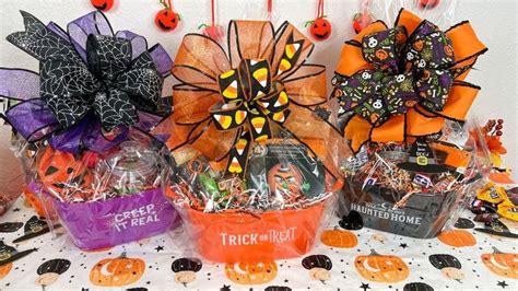 a table topped with halloween baskets filled with candy