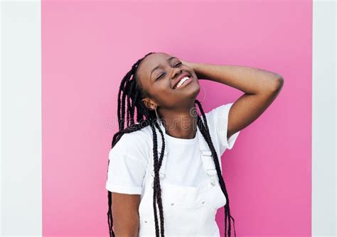 Smiling Female With Closed Eyes Adjusting Her Braided Hair Stock Image