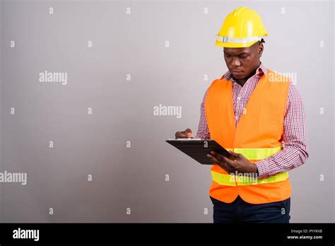 Young African Man Construction Worker Against White Background Stock