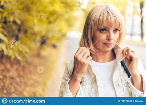 Portrait Of Beautiful Blonde Adult Woman In The Autumn Park On The Nature Walk Outdoors Stock