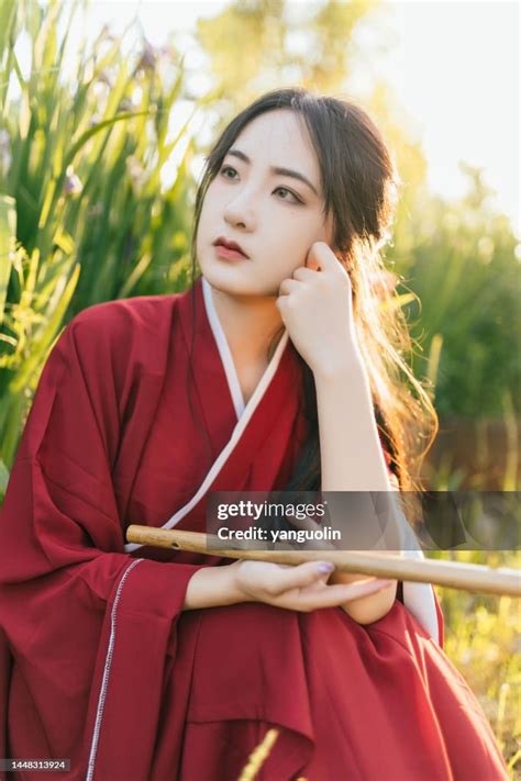 Asian Hanfu Beauties Enjoy Life In The Flowers At Sunset High Res Stock