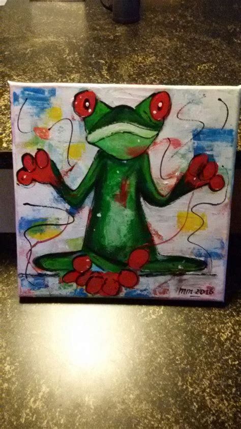 A Painting Of A Green Frog With Red Eyes Sitting On Top Of A Countertop