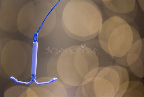 Holding an IUD Birth Control Copper Coil Device, Used for Contraception ...