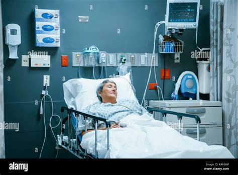 Mixed Race Patient Sleeping In Hospital Bed Stock Photo Alamy